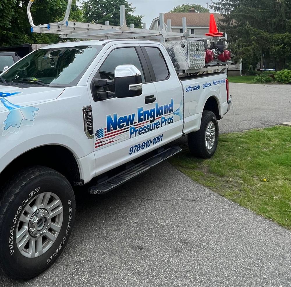 New England Pressure Pros work truck with ladder rack and wash equipment