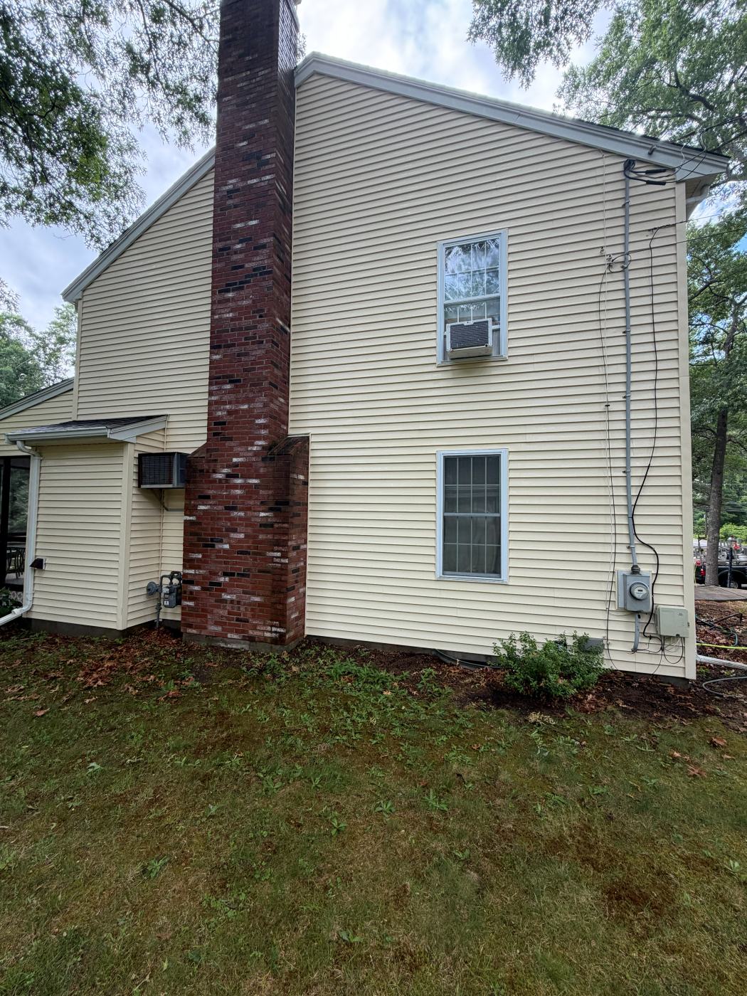 The same siding and chimney after a house wash