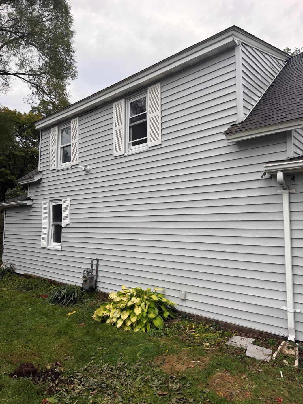 The same gray siding after a house wash